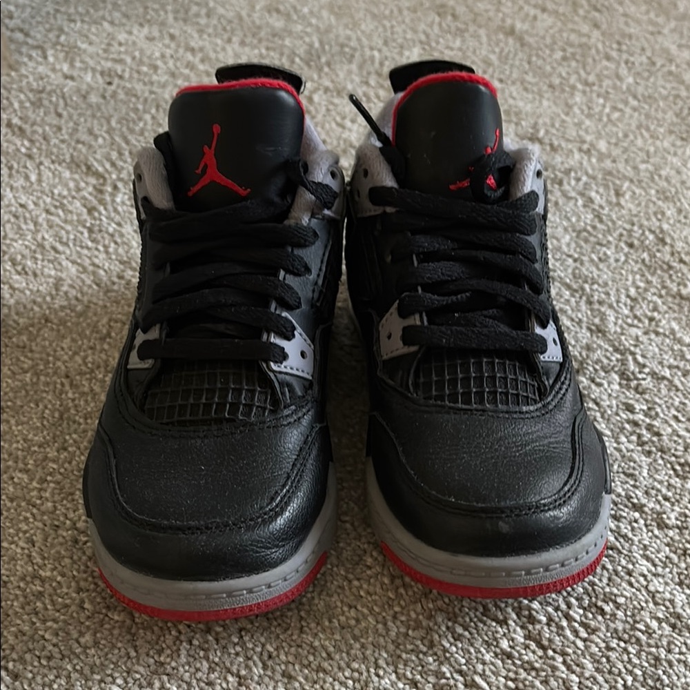 Nike Black and Red Sneakers with Classic AJ4 Design